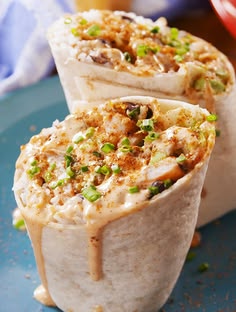 two burritos on a plate with the text old bay shrimp burritos