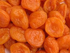 peeled apricots sitting on top of a white plate