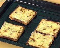 four square pieces of bread sitting on top of a pan