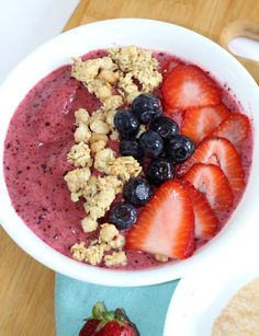 berry smoothie bowl with oatmeal, strawberries and blueberries in it