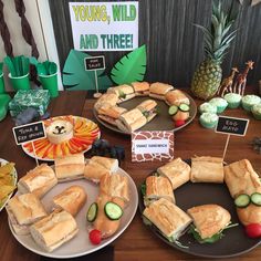 a table topped with plates filled with sandwiches
