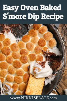 an easy oven baked s'more dip recipe with marshmallows and graham crackers