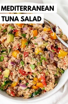 a white bowl filled with tuna salad on top of a table