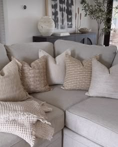 a couch with many pillows on top of it