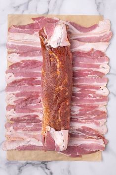 bacon wrapped in strips on a cutting board