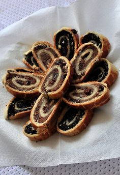 a pile of pastries sitting on top of a white napkin