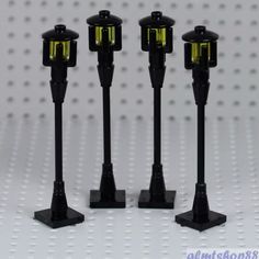 three black and yellow lights on top of each other in front of a white background