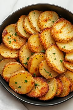 a pan filled with cooked potatoes on top of a table