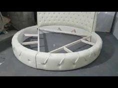a white round bed sitting on top of a floor