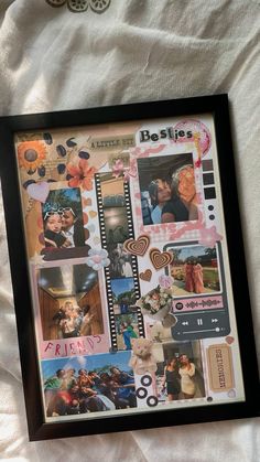 a collage of pictures is displayed in a black frame on a white bed sheet