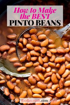 How to Make the BEST Pinto Beans | foodiecrush.com Image shows a closeup shot of a large pot filled with brown pinto beans in a golden brown broth with a bay leaf and a ladle