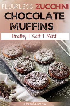 chocolate muffins on a baking sheet with powdered sugar and coffee beans in the background