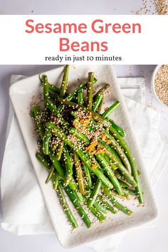 sesame green beans on a white plate with sesame seeds in the background and text overlay reading sesame green beans ready in just 10 minutes