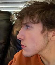 a close up of a person sitting on a couch