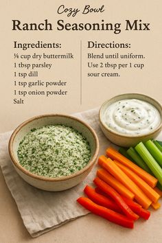 Image features a ranch seasoning recipe card with cozy styling. In the foreground are two ceramic bowls - one filled with a green and white ranch seasoning blend and another holding a creamy dip. Fresh veggie sticks (carrots, celery, red bell pepper) are arranged next to the bowls. The background and soft linen create a warm, inviting feel ideal for homemade kitchen inspiration.