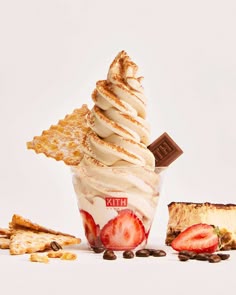 an ice cream sundae with strawberries, chocolate chips and other desserts around it