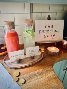 a wooden table topped with two bottles filled with liquid and coins next to a sign that says the pranceing pony