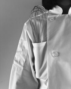 a whisk on the back of a white coat
