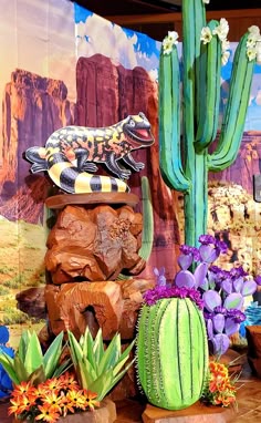 an assortment of plants and animals on display in front of a desert scene with cactuses