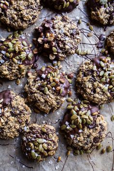 cookies with chocolate and nuts on a sheet of parchment paper