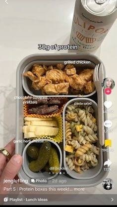 a person is holding up a bento box with food in it and the contents labeled