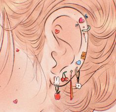 a woman's ear is adorned with various colorful earrings and charms, as well as an apple
