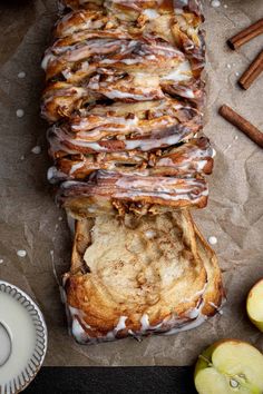 cinnamon apple bread with icing and apples on the side