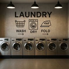 a washer and dryer are lined up against the wall in this laundry room
