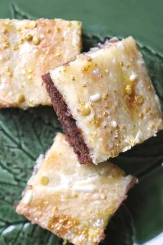 three pieces of cake sitting on top of a green plate