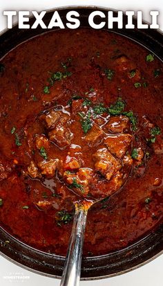 a skillet filled with chili and meat in a red sauce that says texas chili