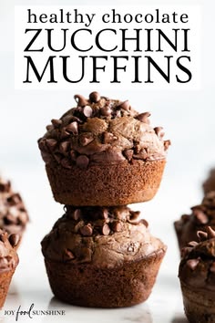 chocolate zucchini muffins stacked on top of each other with text overlay