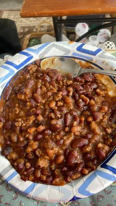 a bowl filled with beans on top of a table