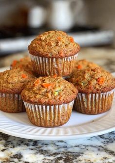several carrot muffins on a white plate