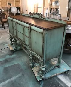 an old dresser is being worked on in a shop