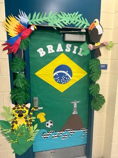 a door decorated with paper cutouts and tropical plants, including parrots, palm trees, and a flag that reads brasil