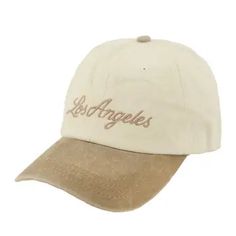 a white and brown hat with the word los angeles on it's front side