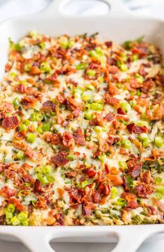 a casserole dish filled with bacon, green onions and cheese