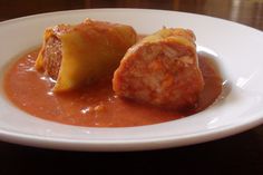 a white plate topped with meatballs covered in sauce