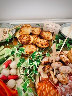 an assortment of meats and vegetables on a platter