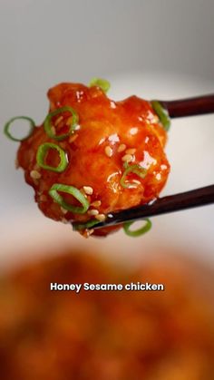 chopsticks with food on them and the words honey sesame chicken written below it