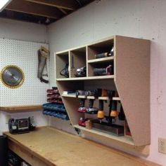 a workbench with lots of tools and supplies on the shelves next to it