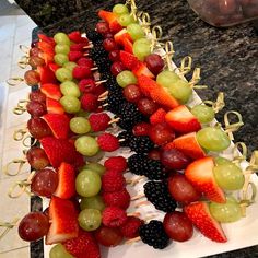 a cake made to look like a tree with fruit on it and strawberries in the middle