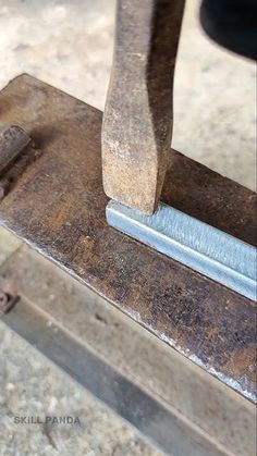a close up of a piece of metal being worked on with a vice and wrench
