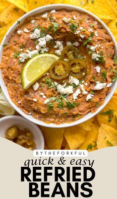 a white bowl filled with refried beans and topped with sliced jalapenos