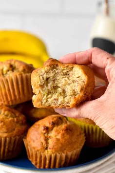 a person holding a banana muffin in their hand