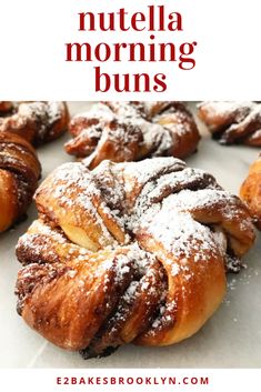 there are many croissants with powdered sugar on top and the words nutella morning buns above them