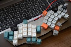 a computer keyboard sitting on top of a wooden desk