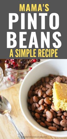 a white bowl filled with beans next to a fork and spoon on top of a wooden table