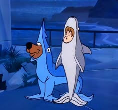the shark and dog are standing next to each other in front of an ocean background