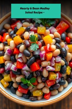 A vibrant 6 bean medley salad with various beans and colorful vegetables in a bowl on a rustic table.